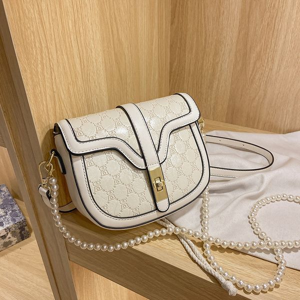 

luxury design handbag 2021 new french niche fashion half round saddle small women's embossed single shoulder slant span bag