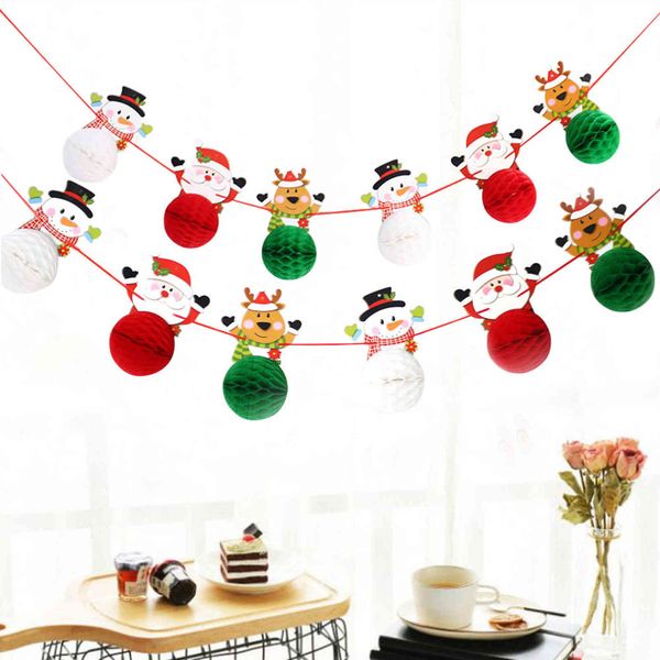 

the venue is decorated with strips, christmas decorations, santa snowman, paper ball flowers