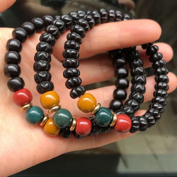 

coconut base pumpkin beads hand string coconut passion seed barrel single loop bracelet, Black