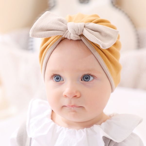 12 pz/lotto di Colore Solido Del Cappello Del Bambino di Bowknot Della Neonata Del Cotone Turbante Nodo Testa Avvolge Capretti Del Bambino Cofano Beanie Neonato Fotografia Puntelli