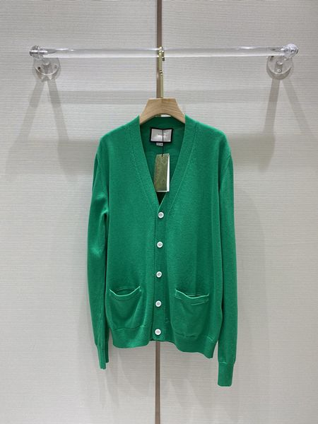 

beautiful emerald green knitted cardigan in early spring 2022, White
