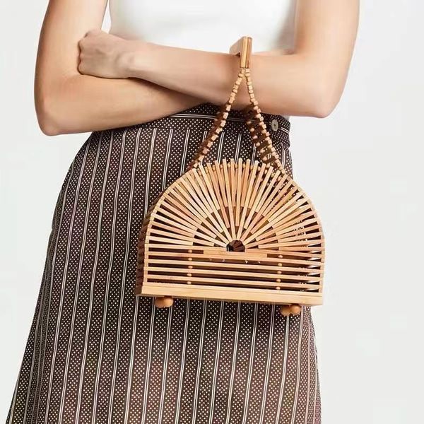 

bamboo woven hand-held makeup bag tapered hollowed-out handbag street s beach ins super 2021 european catwalk style cosmetic bags & cases