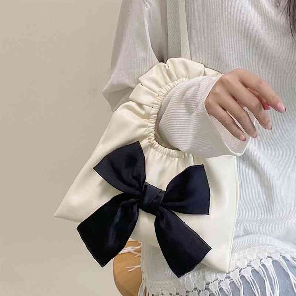 

texture bow, hand carrying small bag, women's 2021 spring and summer new soft leather girl concave shape portable fold bag