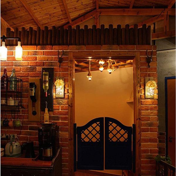 

wall lamps in rustic style with silk hydrangeas and vintage wrought iron hooks indoor outdoor courtyard garden hanging lights