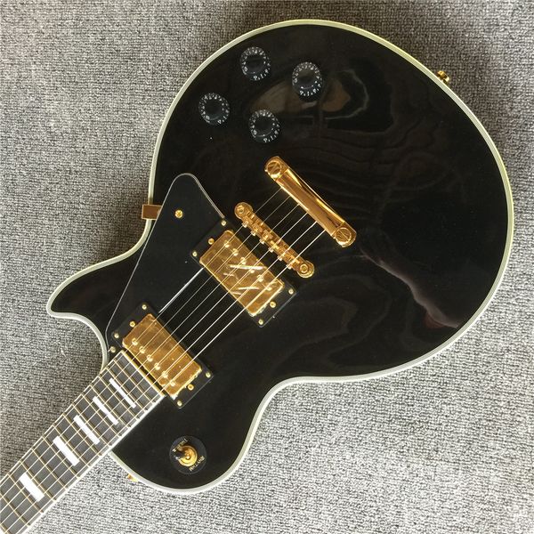

electric guitar, black gloss, gold hardware, in stock