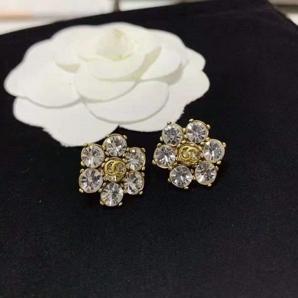 

charms g family flower ear clip large rhinestone advanced versatile 925 silver needle earrings of the same material, Golden