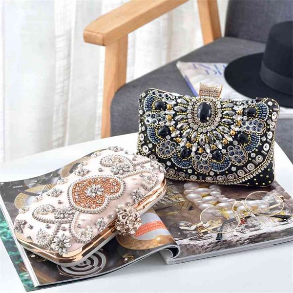 

new hand holding banquet bag with diamond and pearl embroidery
