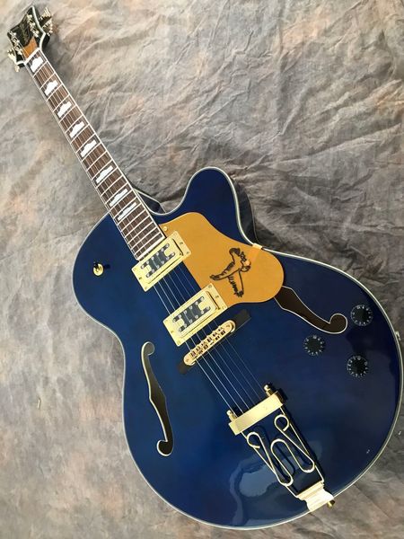 

blue semi-hollow jazz electric guitar with gold bird pick guard f hole