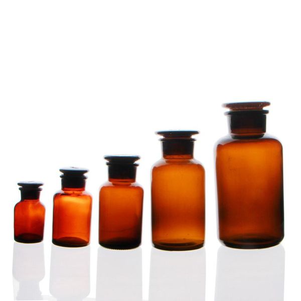 

lab supplies brown jars, frosted glass sers, sealed bottles, laboratory equipment, various sizes