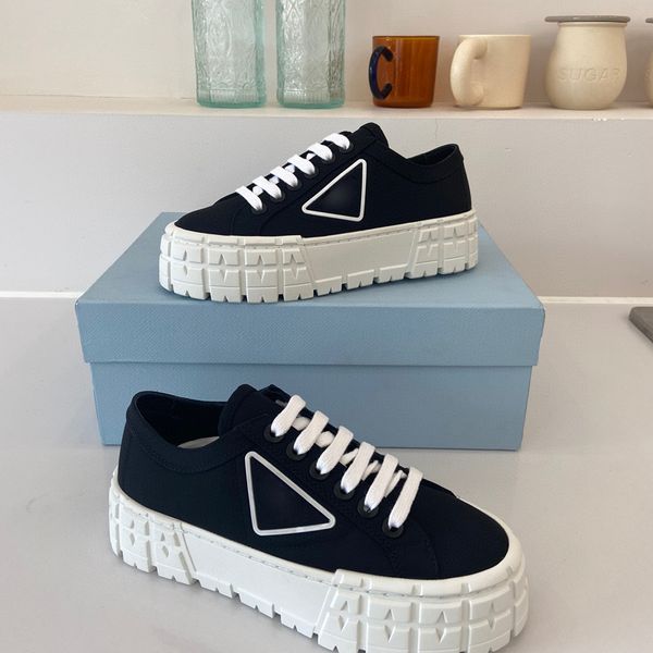 

8 color rubber platform inspired by motocross tires defines the unusual design of these nylon gabardine sneakers. the logo triangle decorate, Black