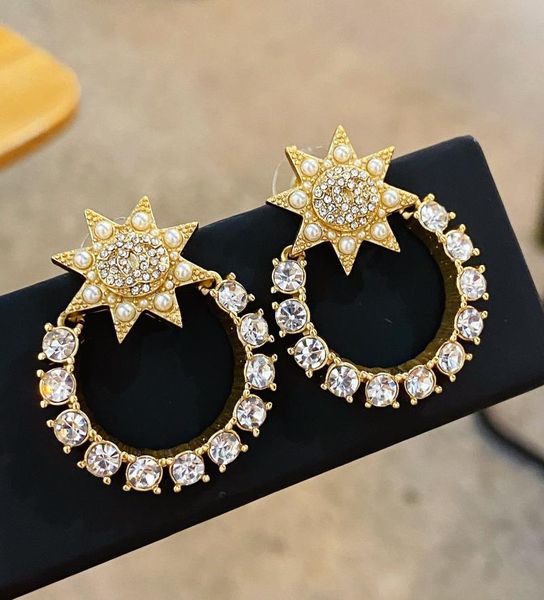 

stud the latest sunflower star studded brass earrings in pearl shape, Golden;silver