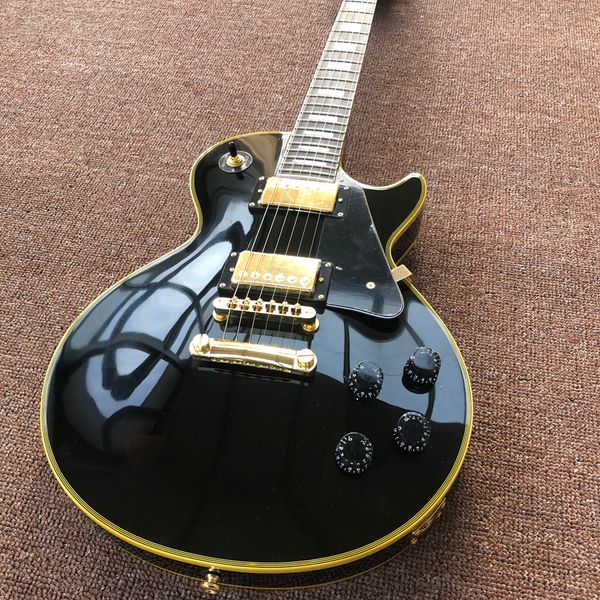 

electric guitar,yellow binding,rosewood fingerboard,black custom,gold hardware