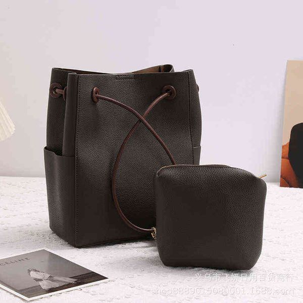 

designers bags cowhide one shoulder women's bag high sense texture bucket spring and summer simple leisure fox wool ball pendant