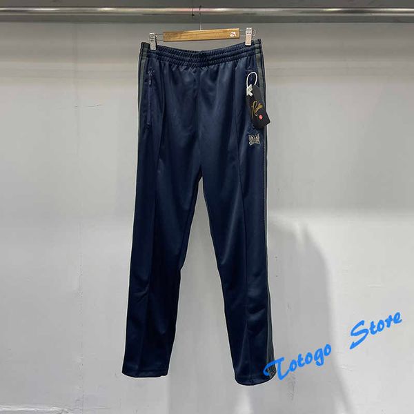 Pantaloni con aghi blu navy Pantaloni da jogging da donna da uomo Pantaloni sportivi con tasca con cerniera con coulisse e ricamo a farfalla in materiale morbido