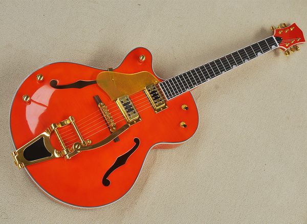

left hand semi-hollow orange electric guitar with big tremolo
