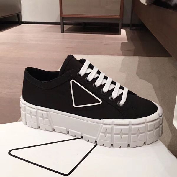 

rubber platform inspired by motocross tires defines the unusual design of these nylon gabardine sneakers. the triangle decorate50 mm, Black