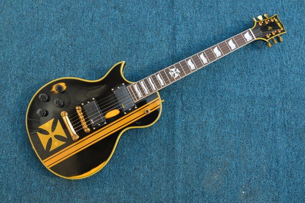 

left hand aged black lp electric guitar gold hardware building yellow