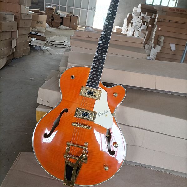 

6 string orange semi-hollow electric guitar with rosewood fretboard cream pickguard