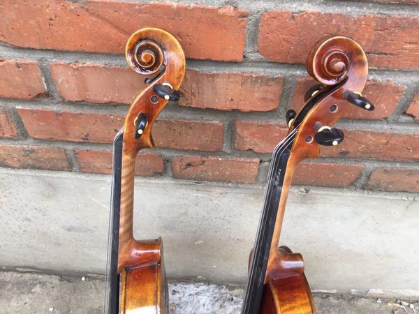 

two violins 4/4 size maple back with hand crabed words old spruce top