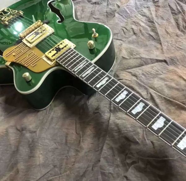 

green semi-hollow jazz electric guitar with gold bird pick guard f hole