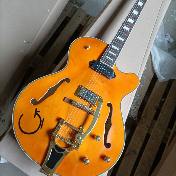 

6 string orange semi-hollow electric guitar with big tremolo rosewood fretboard