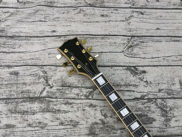 

70s black custom electric guitar, binding over frets