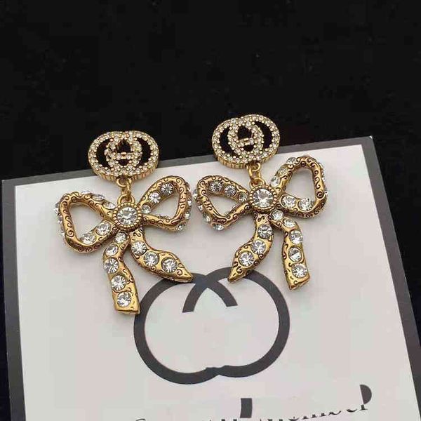 

i bow earring design interlocking classic matching earrings made of brass, Golden