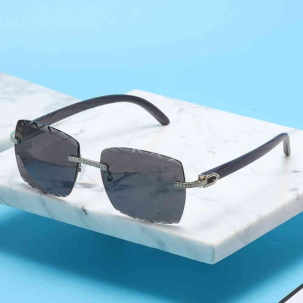 

2022 fashion brand design sunglasses factory direct sales trendy clothing frameless edge women's advanced feeling diamond, White;black