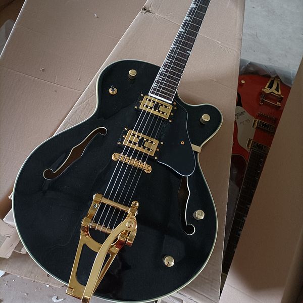

6 string black semi-hollow electric guitar with black pickguard rosewood fretboard