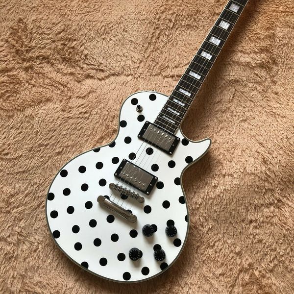 

white background black dot 6 string electric guitar