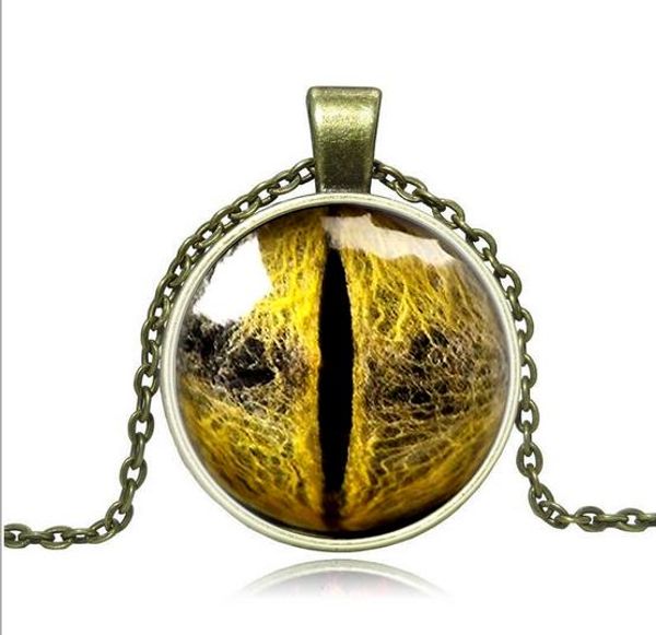 

vintage style unisex, yellow eye, necklace with circle pedant, gold and silver colors, and