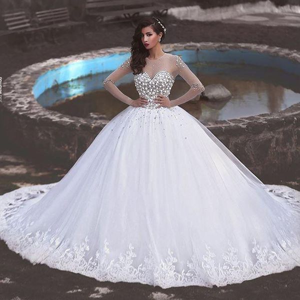 Splendidi cristalli Abito da sposa Abito da ballo Scollo gioiello trasparente Maniche lunghe Top in rilievo Abiti da sposa in tulle Orlo con applicazioni di pizzo