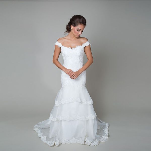 

lace three tiers of flowing organza with lace trim off the shoulder sweetheart neckline low back and a chapel train mermaid bridal dress, White