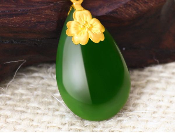 O ouro ajustou-se com a colar verde do jade A flor ameixa bolha-dada forma, florescendo floresce. Pingente de colar.