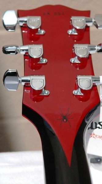 

in stock quilted maple black red widow electric guitar ebony fingerboard, reddish binding & split diamond logo, emg pickups, blackhardware,