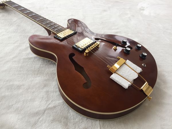 

electric guitar hollow body,deep brown see thru wood grain.gold parts.ing