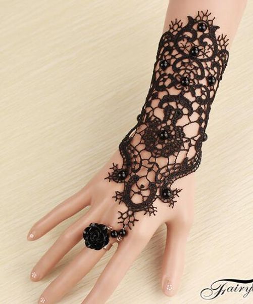 

new the dress is accessorised with black lace bracelet and ring, integrated armband, fashion and classic elegance, Golden;silver