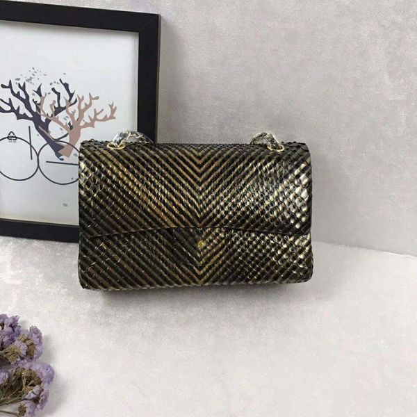 

The new european tyle luxury cla ic houlder bag made of metallic gold python nake party tripe golden necklace decoration