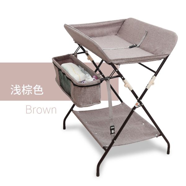 

nappy baby care table, newborn baby touching table multifunctional massage table, folding clothes hanging objects light brown