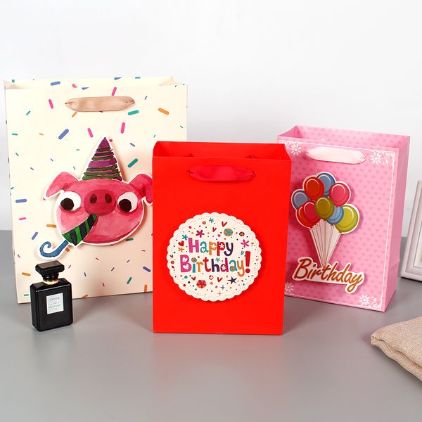 

cartoon paper gift bags with cute pig snout / balloon / birthday tip-ons holding gifts happy children's day
