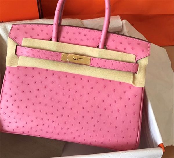 

whosale fully handmade pink ostrich skin design purse 30cm wax thread, have both gold and silver hardware,contact me for details