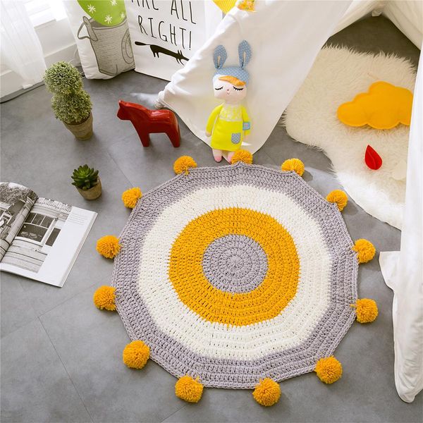 

adeeing hand knitted round floor mat with plush balls for bay window sill