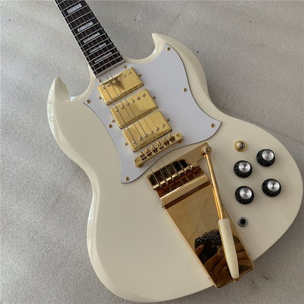 

white electric guitar, gold accessories