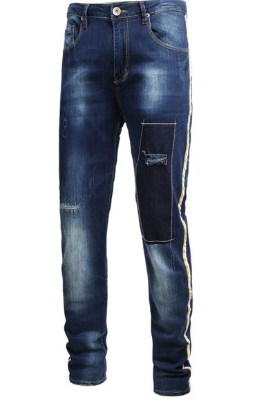 

embroidered ribbons adorn large men's jeans with holes, Blue