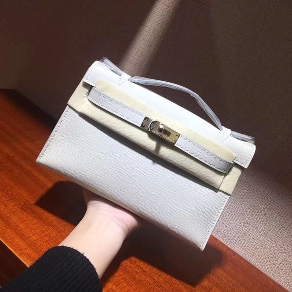 

ladies classic evening bag. designer clutch bag. clamshell design palm print leather strap closure closure. fashion lady style