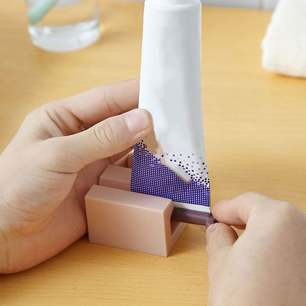 

creative toothpaste dispenser rolling toothpaste squeezer stand holder home l bathroom rack portable travel