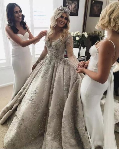 

Luxury arabic long leeve wedding dre e 2019 new elegant heer neck illu ion back lace beaded cry tal bridal gown cu tom made