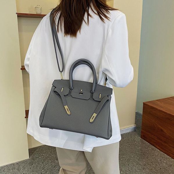 

Sales factory ladies shoulder bag daily Joker solid color large fashion messenger bag elegant atmosphere ribbon handbag simple embossed lychee pattern handbag, Orange