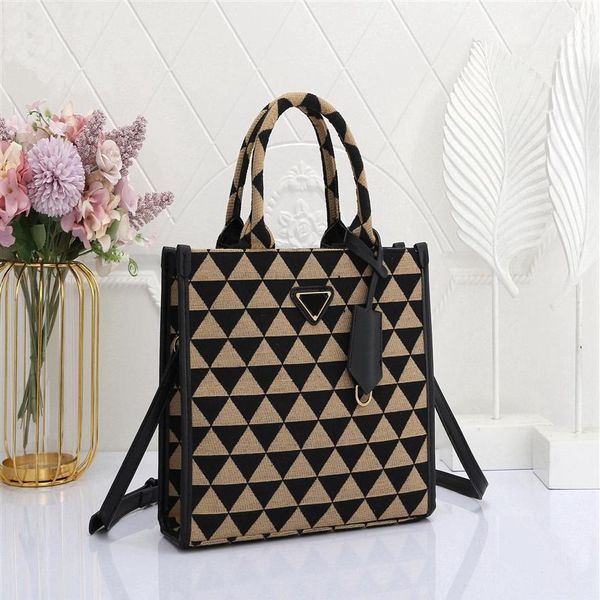 

classic triangle-shaped tote bag with a single shoulder strap strap and detachable leather key chain2556
