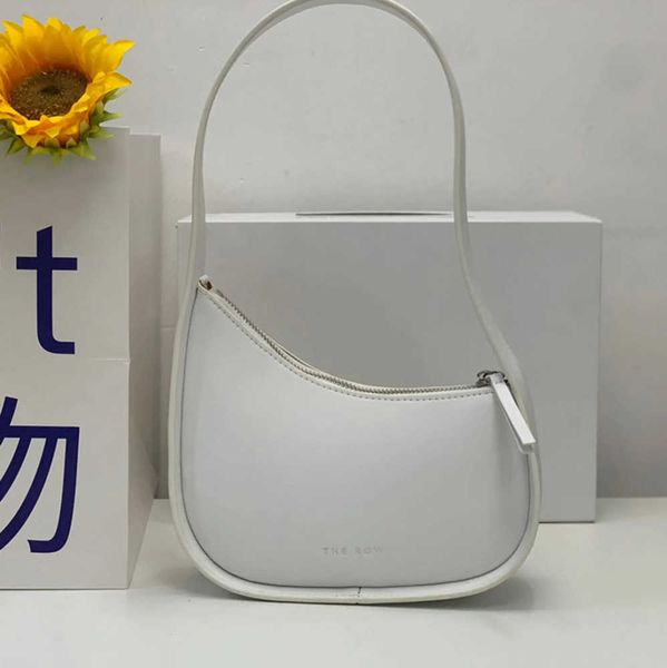 

the row half moon bag smooth leather women designer with flat shoulder strap and curved zipper closure clutch tote suded lining underarm bag